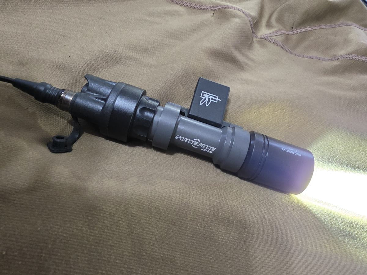 SureFire® weapon light with Malkoff LED conversion head, powered on
